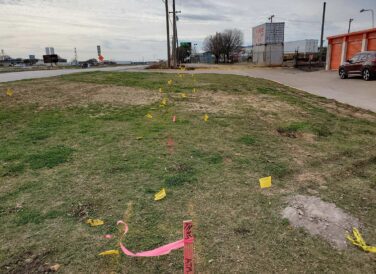 flag markings in the ground for Diamond Interchange right of way project